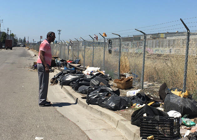 Supervisor Miley sweeping the street, raising awareness on illegal dumping