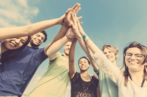 Young adults all gathered together with high fives