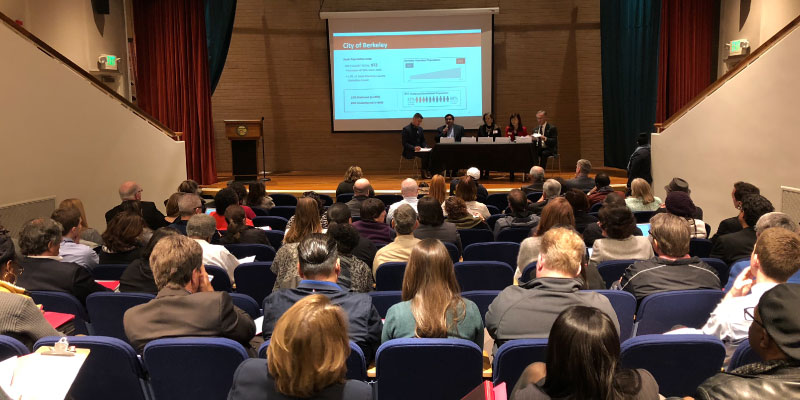 Photo of audience listening to a panel discussion.