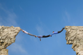 3 men hanging off a cliff